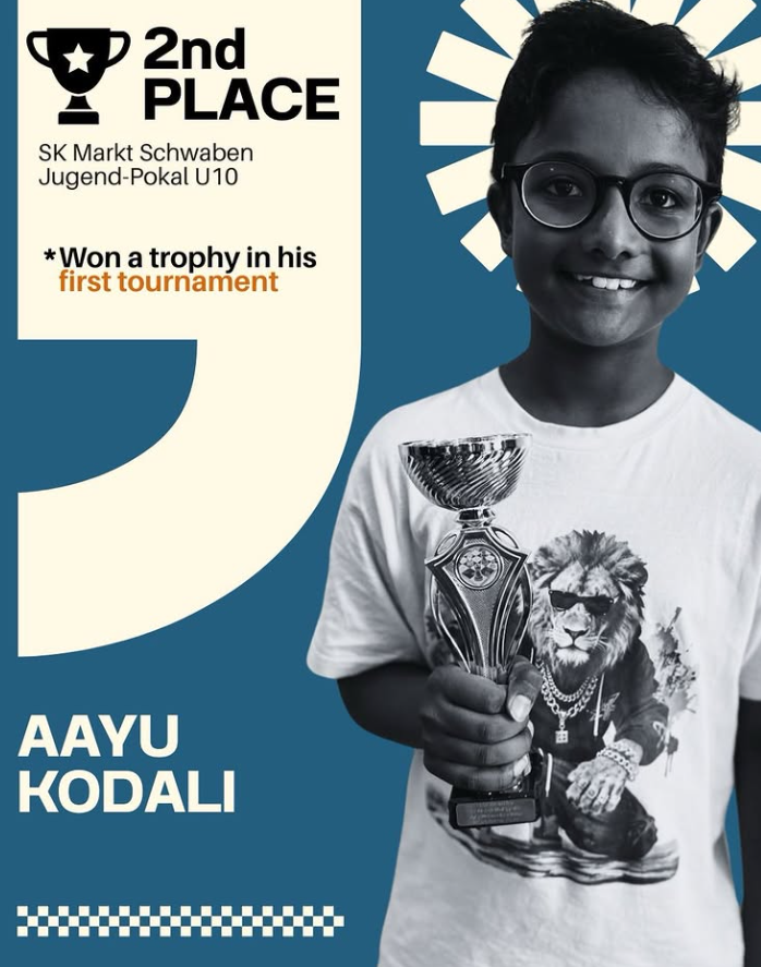 Aayu Kodali holding his chess trophy